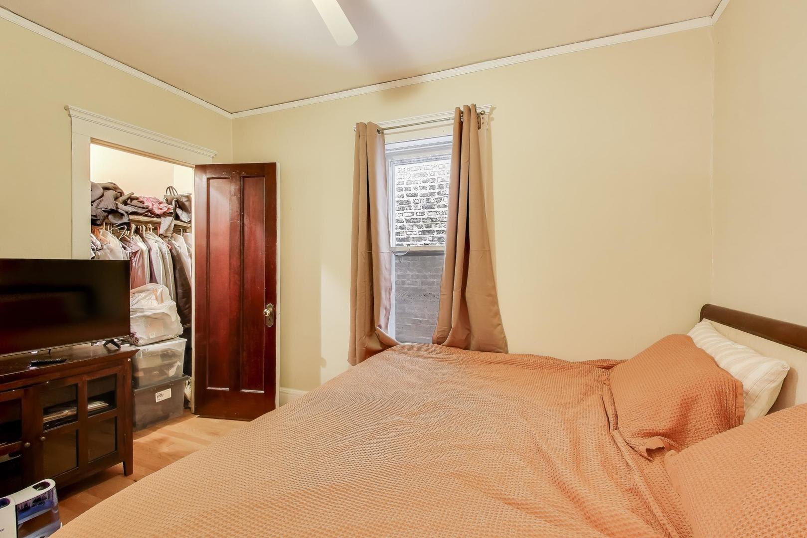 2245 West Giddings Street Chicago, IL 60625 - Photo 35 of 50 a bedroom with a bed and a flat screen tv