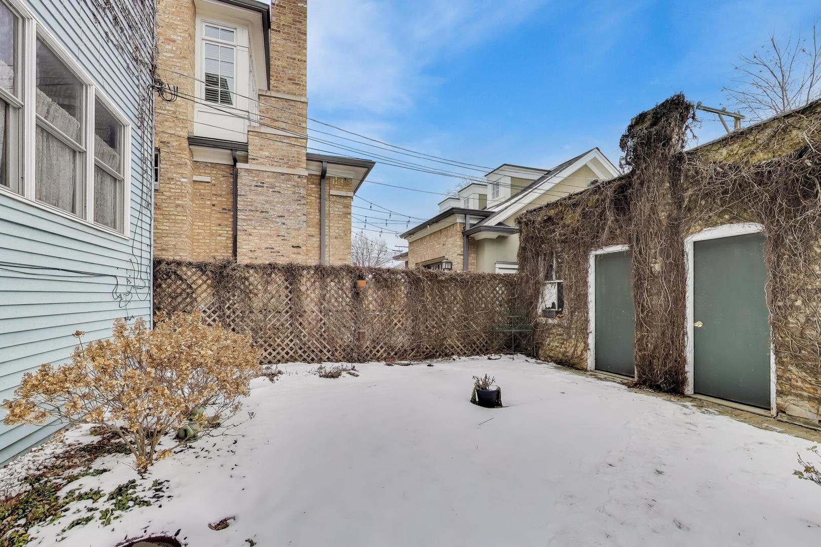 2245 West Giddings Street Chicago, IL 60625 - Photo 44 of 50 a view of a house with a snow in the yard