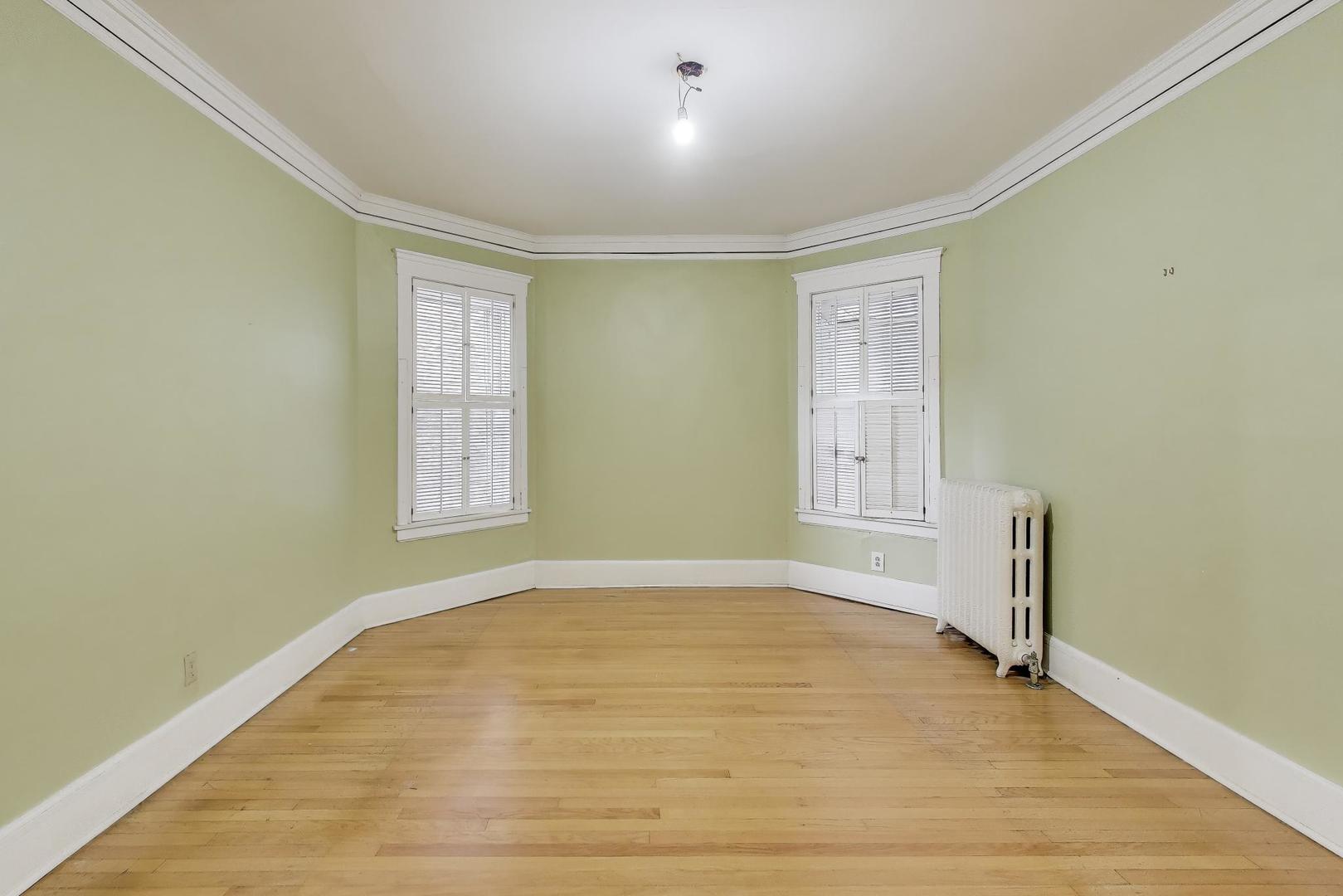 2245 West Giddings Street Chicago, IL 60625 - Photo 7 of 50 a view of empty room with wooden floor and fan