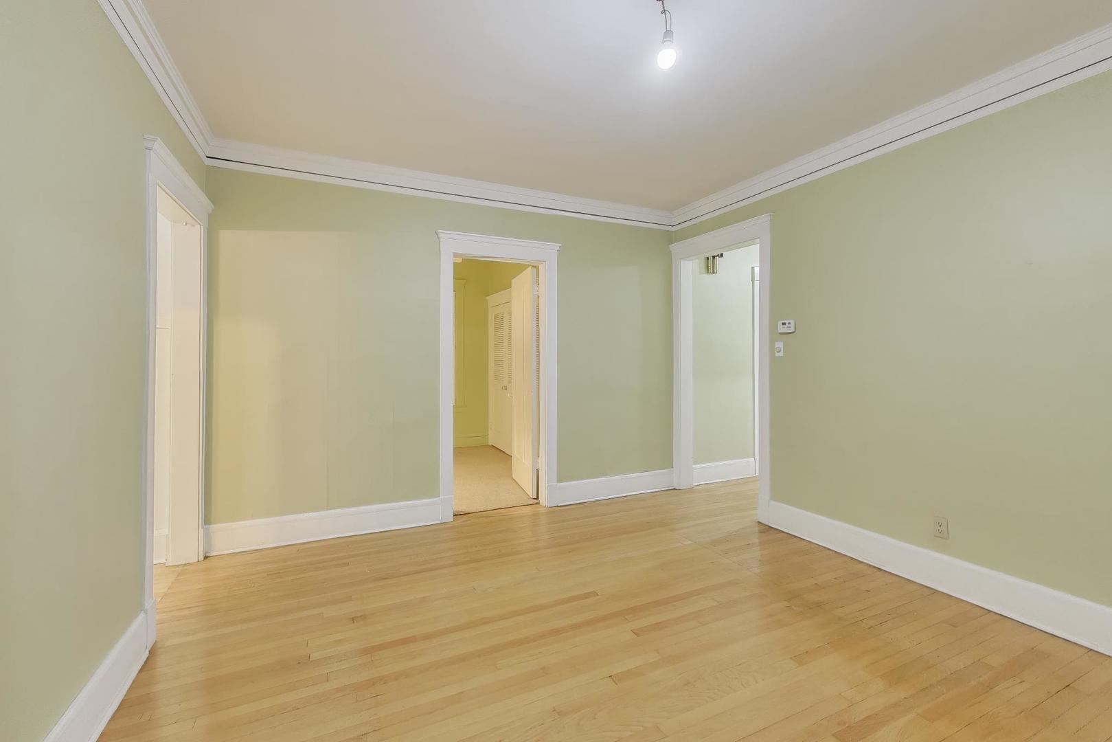 2245 West Giddings Street Chicago, IL 60625 - Photo 8 of 50 a view of an empty room with wooden floor