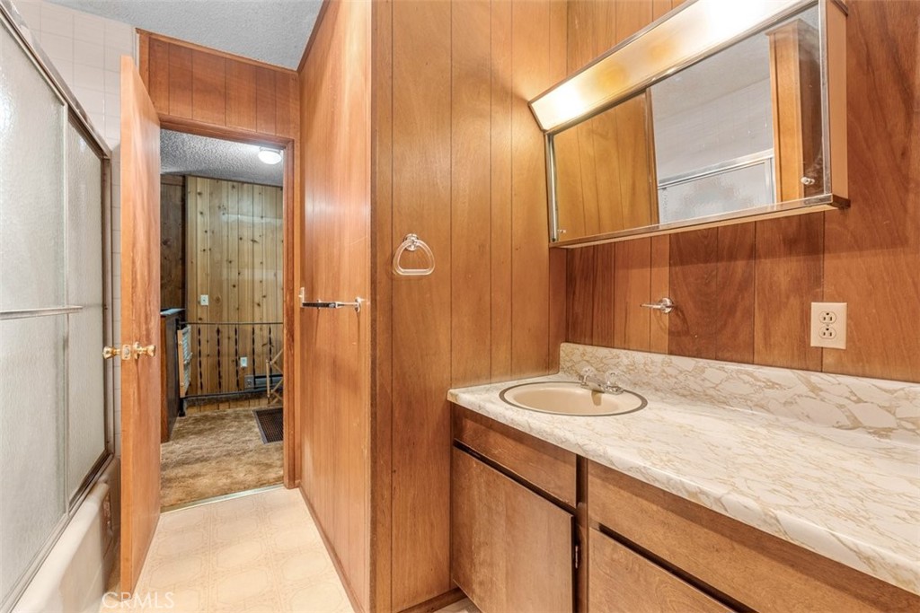 1056 Lark Road Wrightwood, CA 92397 - Photo 15 of 40 a bathroom with a granite countertop sink and a mirror