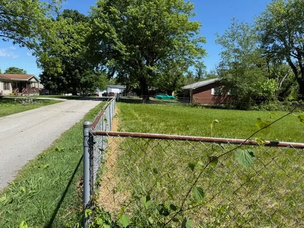 a view of a yard with basketball court