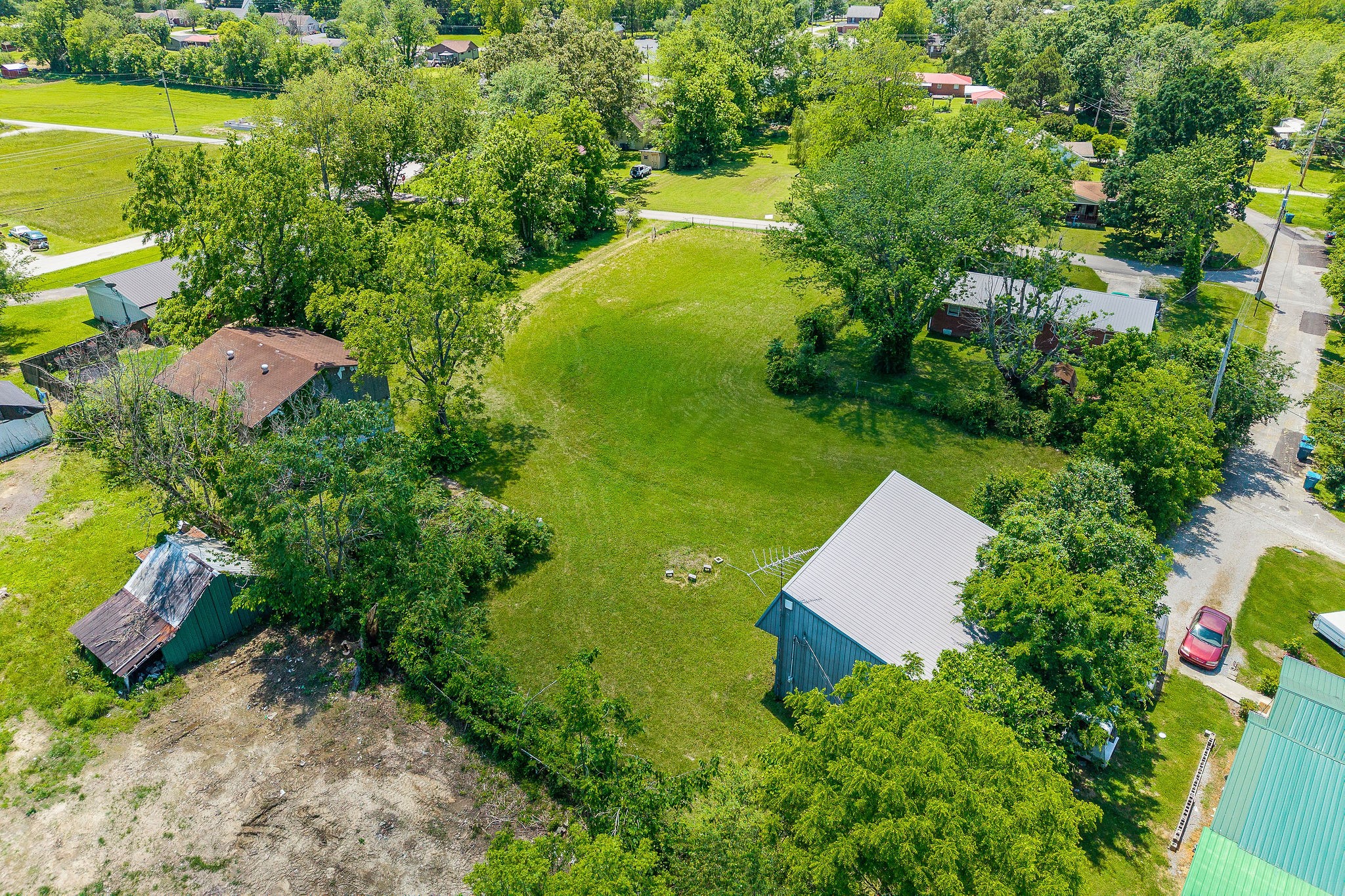 214 5th Avenue South Baxter, TN 38544 - Photo 4 of 20 an aerial view of residential house with outdoor space and trees all around