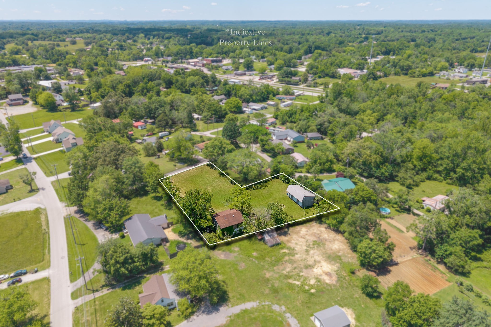 214 5th Avenue South Baxter, TN 38544 - Photo 5 of 20 an aerial view of residential houses with outdoor space and trees