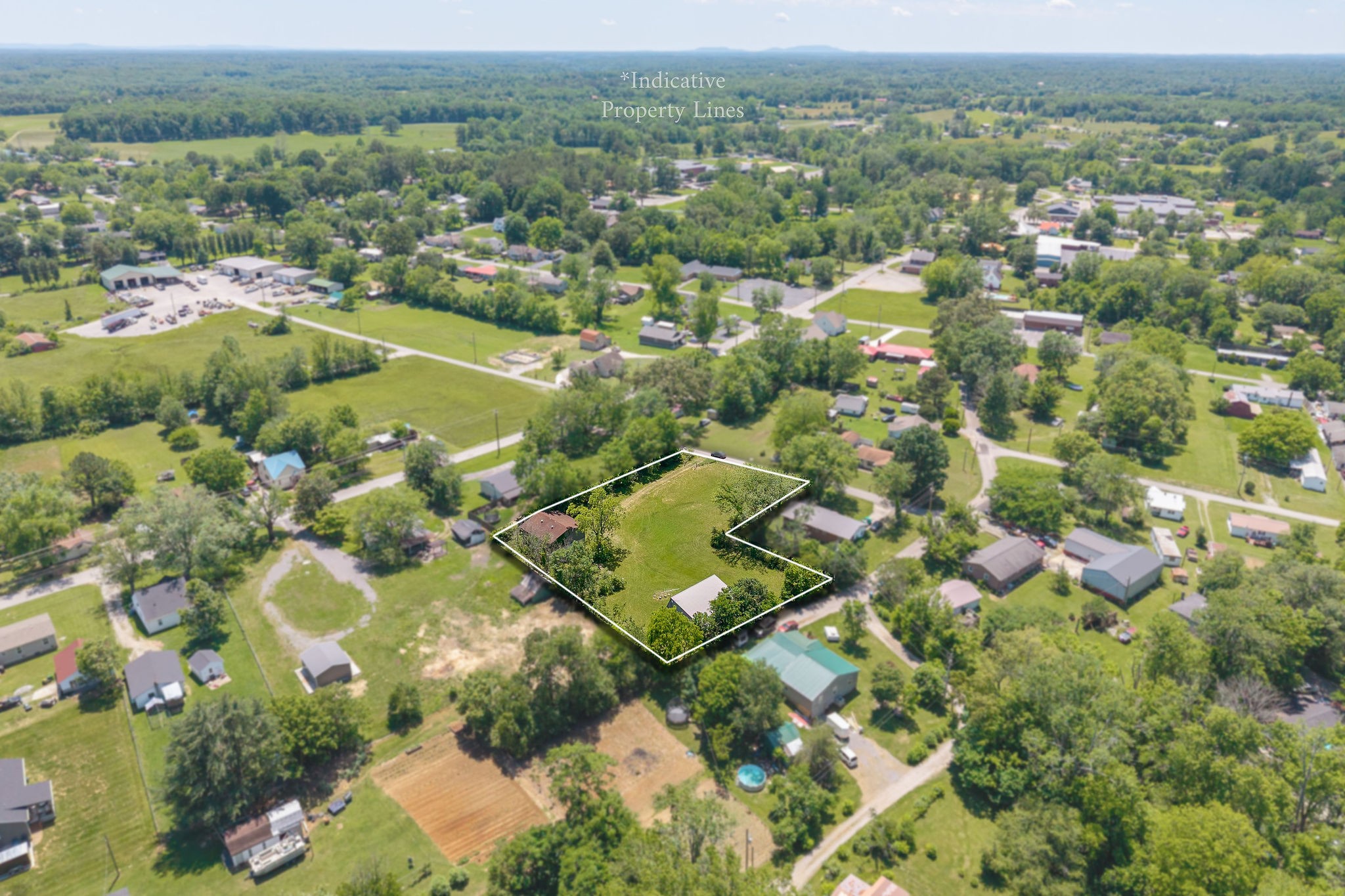 214 5th Avenue South Baxter, TN 38544 - Photo 7 of 20 an aerial view of residential houses with outdoor space and trees