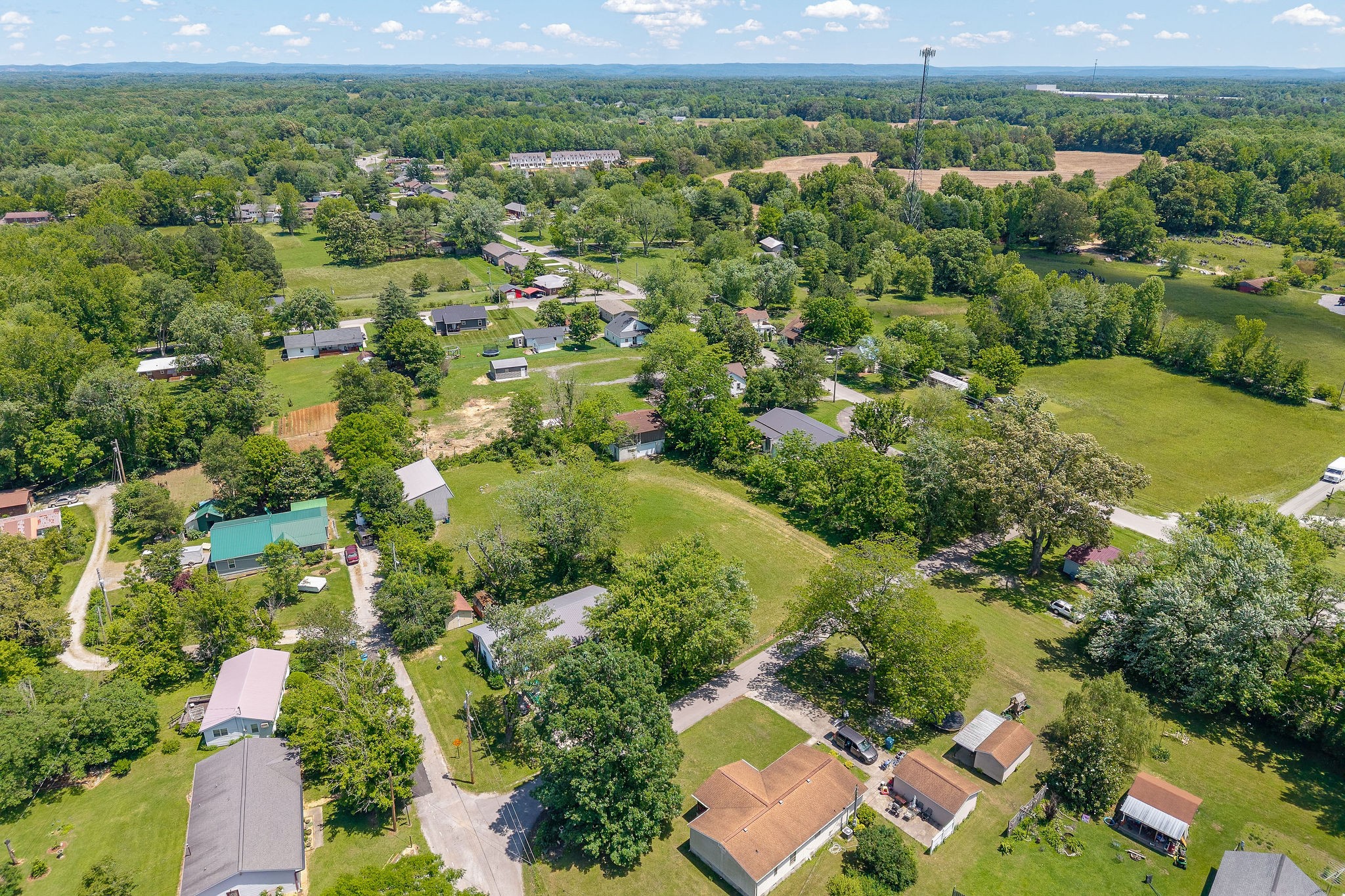 214 5th Avenue South Baxter, TN 38544 - Photo 10 of 20 an aerial view of residential houses with outdoor space and trees