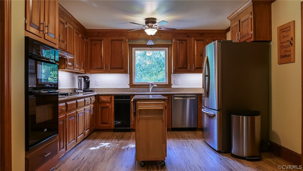 13000 River Road Chesterfield, VA 23838 - Photo 11 of 50 a kitchen with granite countertop a refrigerator stove and wooden floor