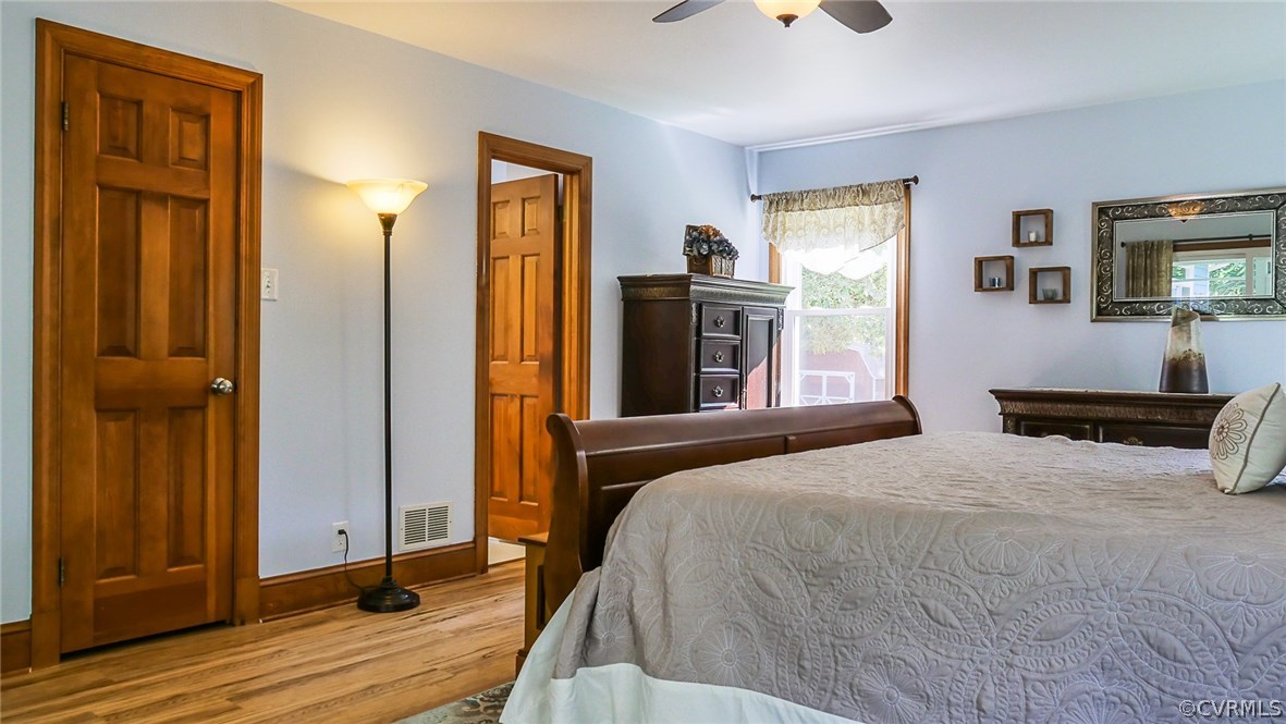 13000 River Road Chesterfield, VA 23838 - Photo 22 of 50 a bedroom with a bed and a flat tv screen on dresser