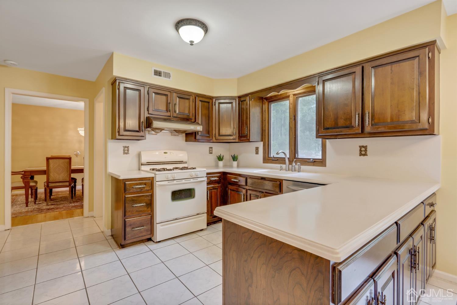 6 Fox Hill Road Edison, NJ 08820 - Photo 8 of 26 a kitchen with stainless steel appliances a stove sink and cabinets