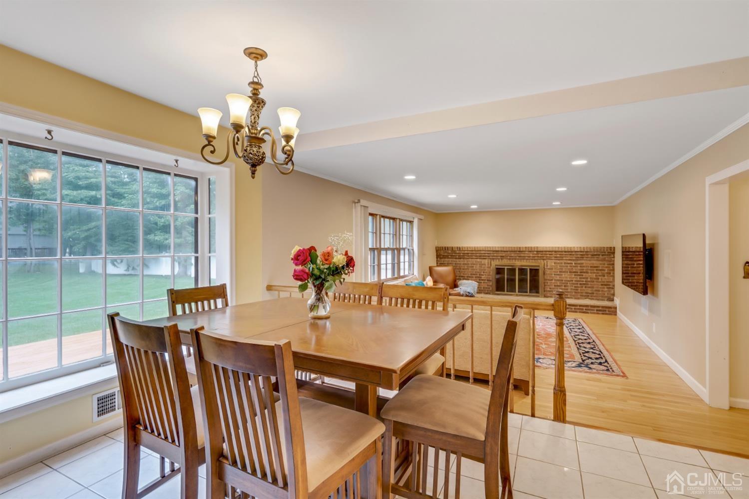 6 Fox Hill Road Edison, NJ 08820 - Photo 9 of 26 a view of a dining room with furniture a chandelier and wooden floor
