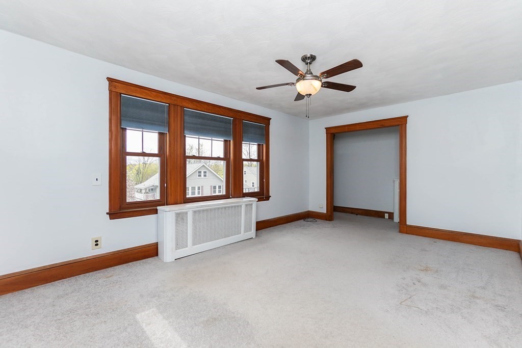 45 Redlands Road Boston, MA 02132 - Photo 11 of 41 an empty room with windows and ceiling fan