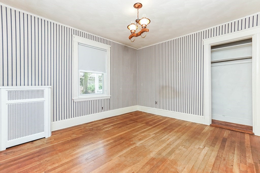 45 Redlands Road Boston, MA 02132 - Photo 14 of 41 an empty room with wooden floor and windows