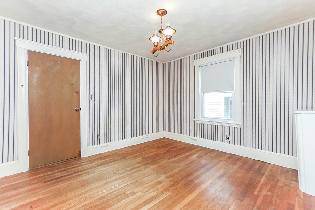 45 Redlands Road Boston, MA 02132 - Photo 15 of 41 a view of an empty room with wooden floor and a window