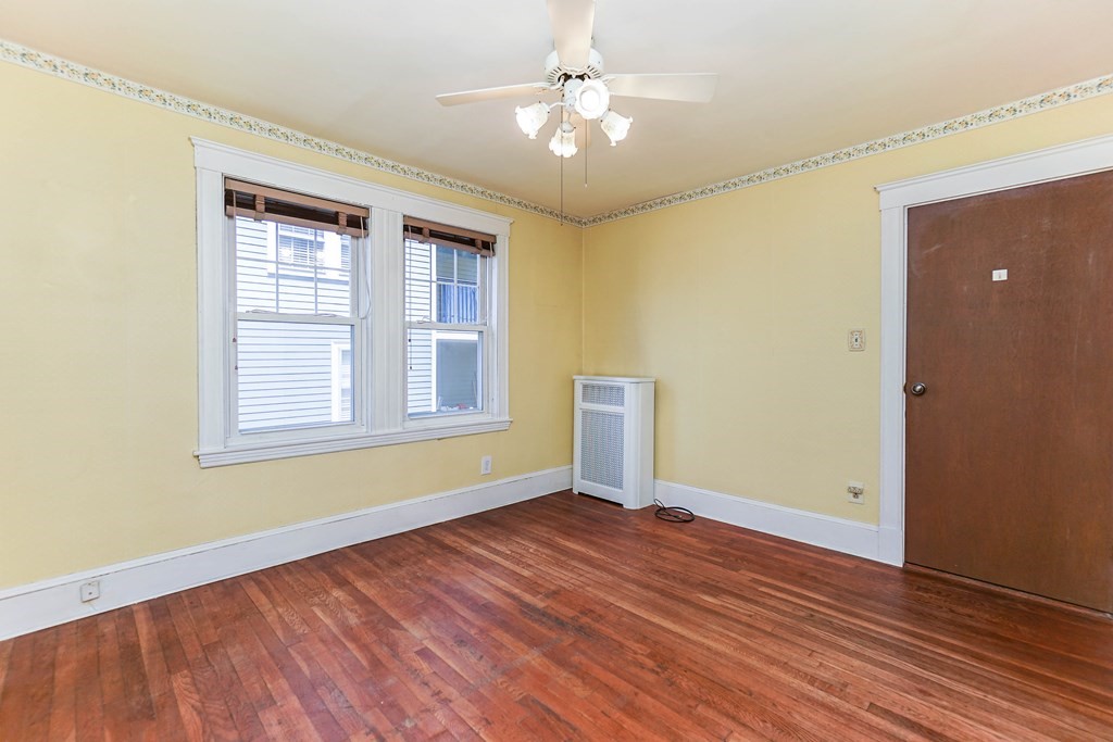 45 Redlands Road Boston, MA 02132 - Photo 17 of 41 wooden floor in an empty room with a window