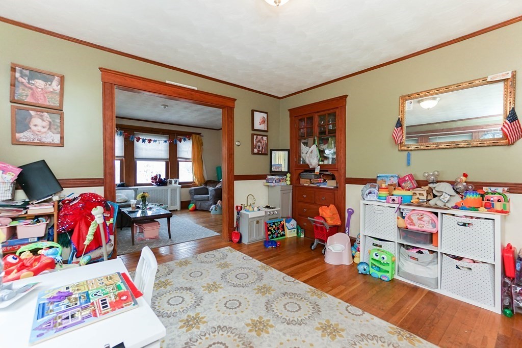 45 Redlands Road Boston, MA 02132 - Photo 23 of 41 a playing room with furniture and a wooden floor