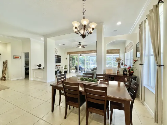 a view of a dining room with furniture and a chandelier