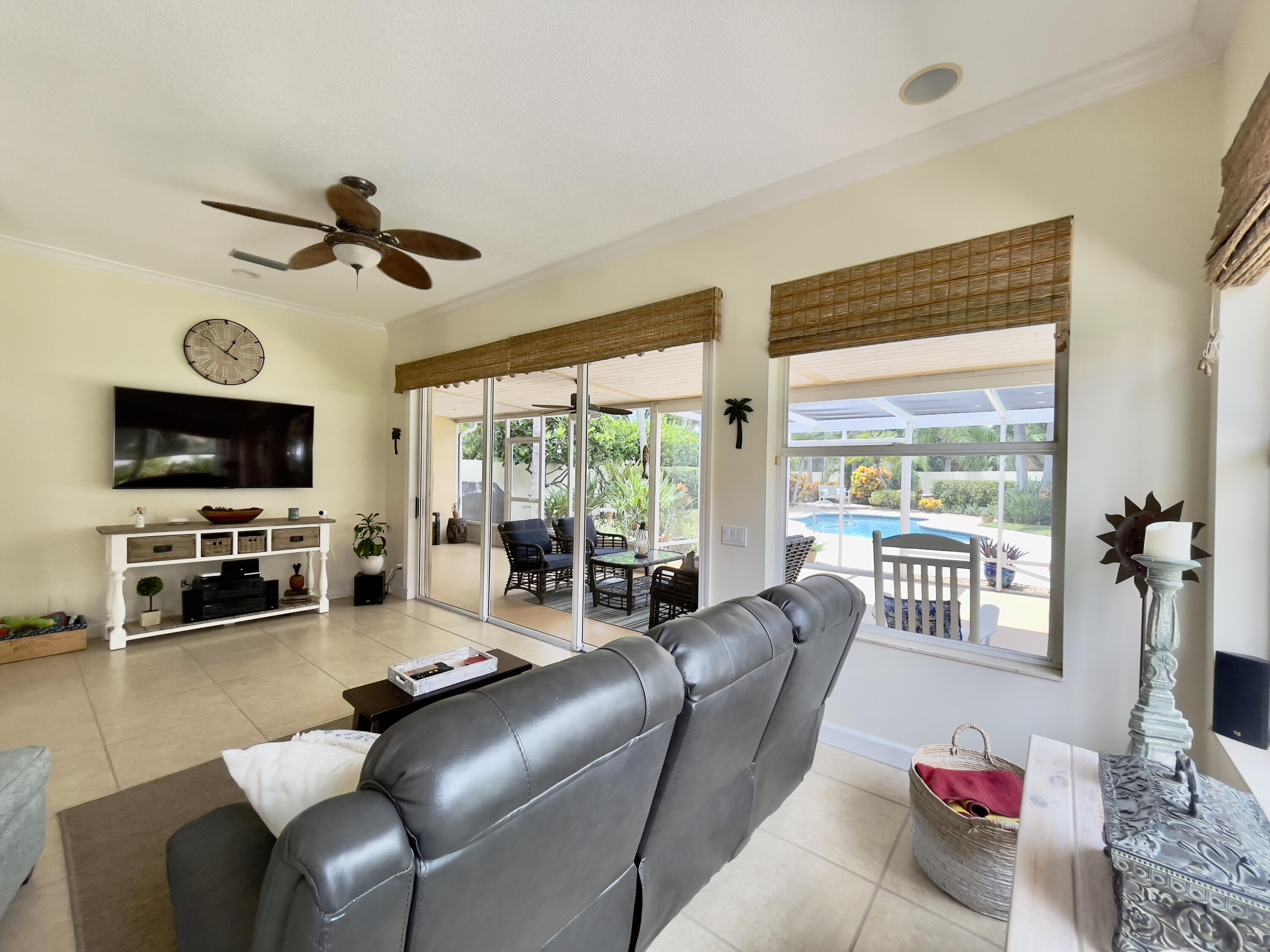 174 Hampton Circle Jupiter, FL 33458 - Photo 16 of 45 a living room with furniture a flat screen tv and a large window