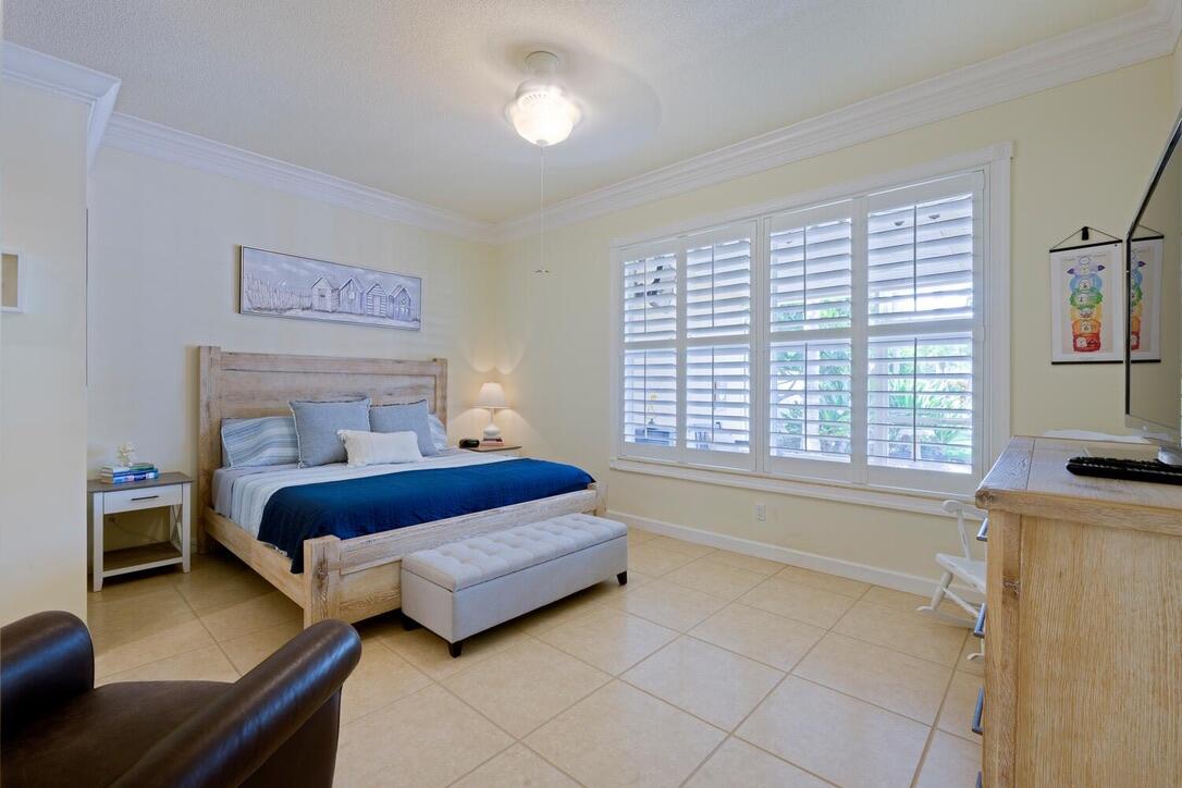 174 Hampton Circle Jupiter, FL 33458 - Photo 17 of 45 a bedroom with a bed and a window