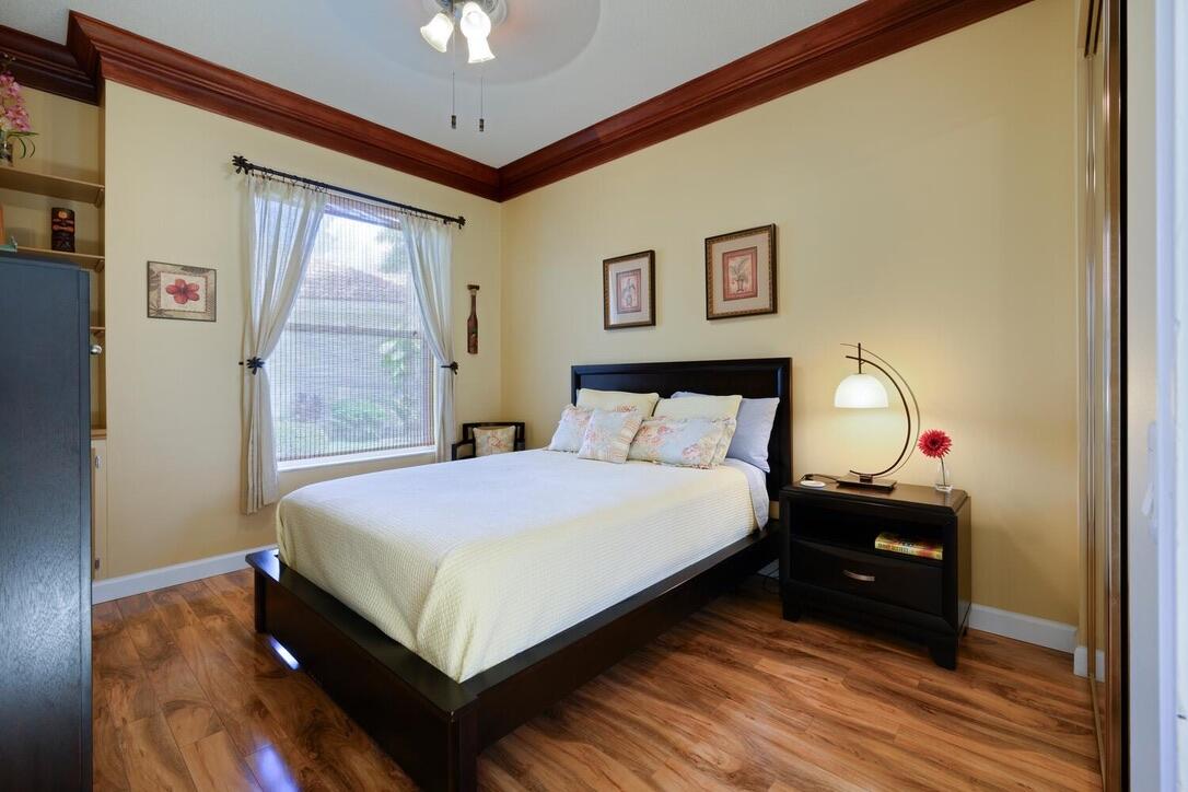 174 Hampton Circle Jupiter, FL 33458 - Photo 23 of 45 a bedroom with a bed and a mirror