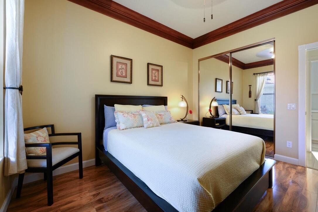 174 Hampton Circle Jupiter, FL 33458 - Photo 24 of 45 a bedroom with a bed and wooden floor