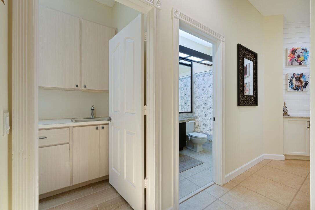 174 Hampton Circle Jupiter, FL 33458 - Photo 26 of 45 a view of bathroom with a sink and mirror