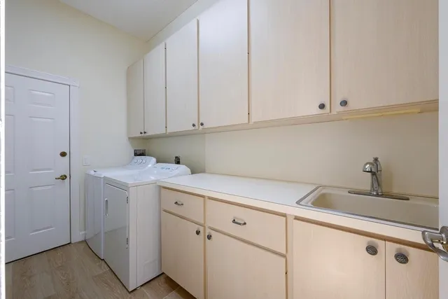 a kitchen with white cabinets and white appliances