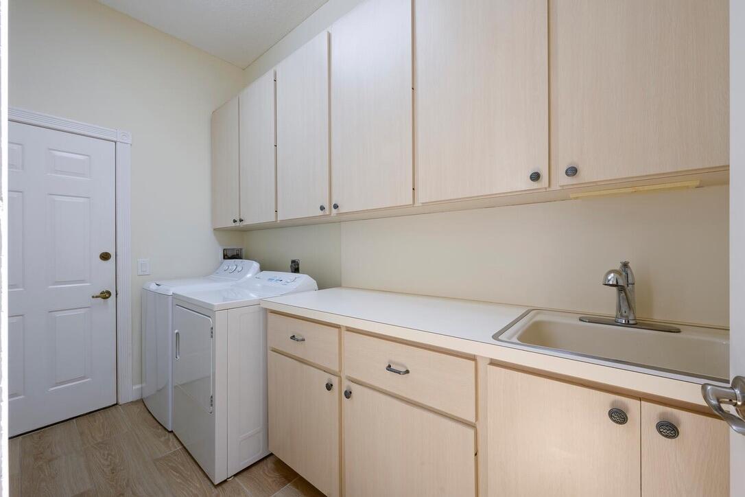 174 Hampton Circle Jupiter, FL 33458 - Photo 27 of 45 a kitchen with white cabinets and white appliances