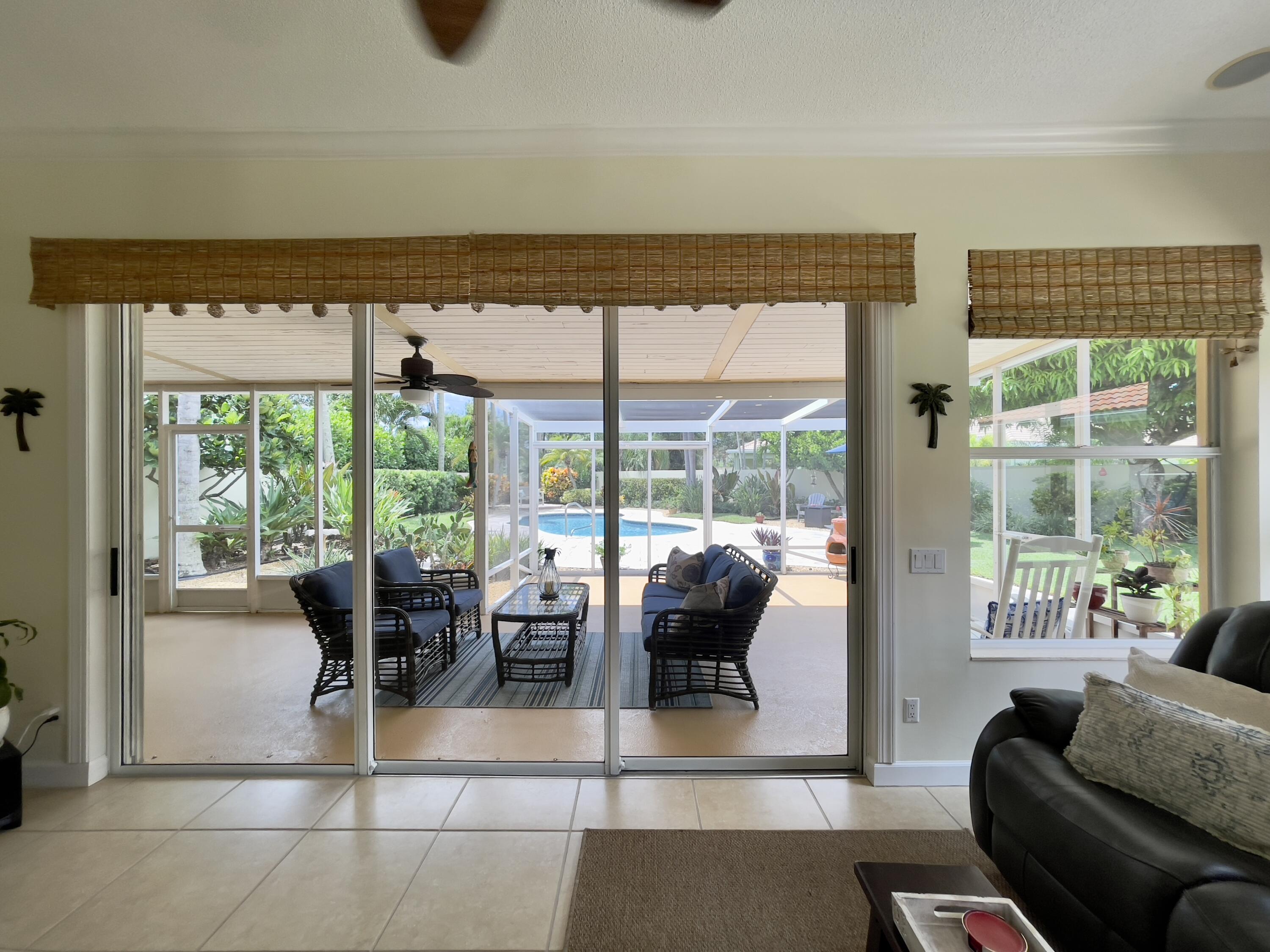 174 Hampton Circle Jupiter, FL 33458 - Photo 29 of 45 a living room with furniture and a floor to ceiling window
