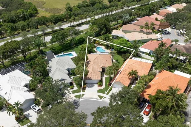 an aerial view of multiple houses with yard