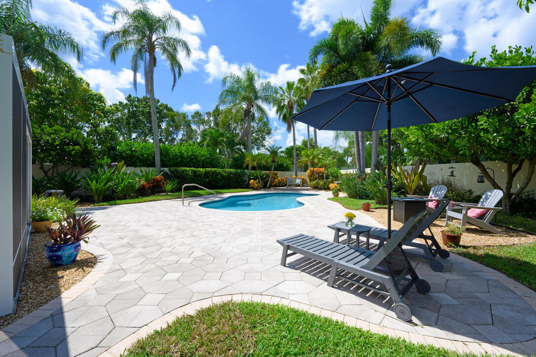 174 Hampton Circle Jupiter, FL 33458 - Photo 33 of 45 a view of a backyard with furniture and a garden