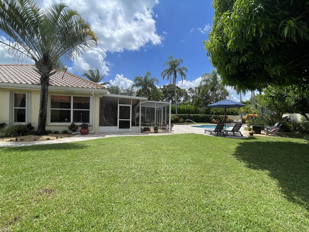 174 Hampton Circle Jupiter, FL 33458 - Photo 34 of 45 a front view of house with yard and outdoor seating
