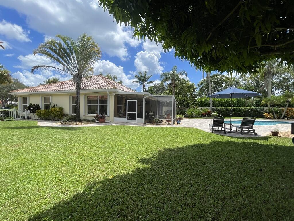 174 Hampton Circle Jupiter, FL 33458 - Photo 35 of 45 a front view of a house with a garden