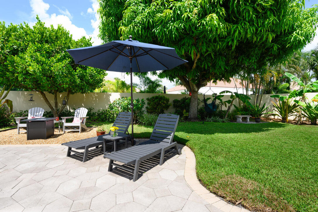 174 Hampton Circle Jupiter, FL 33458 - Photo 38 of 45 a view of a backyard with sitting area and furniture
