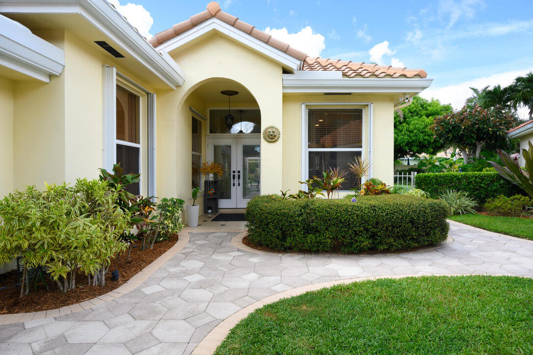 174 Hampton Circle Jupiter, FL 33458 - Photo 5 of 45 a front view of a house with garden