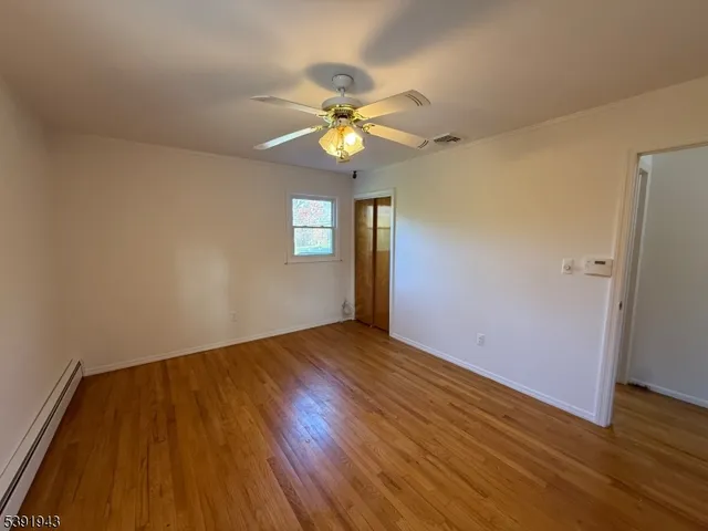 an empty room with windows and fireplace