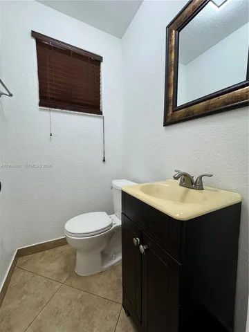 a bathroom with a sink toilet and mirror
