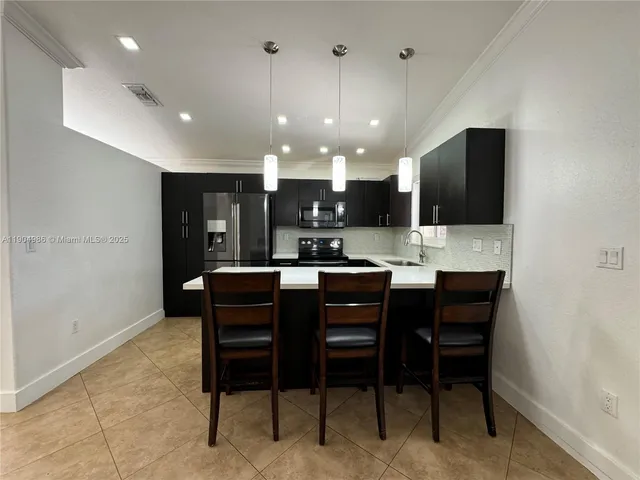 a kitchen with a dining table chairs and view kitchen