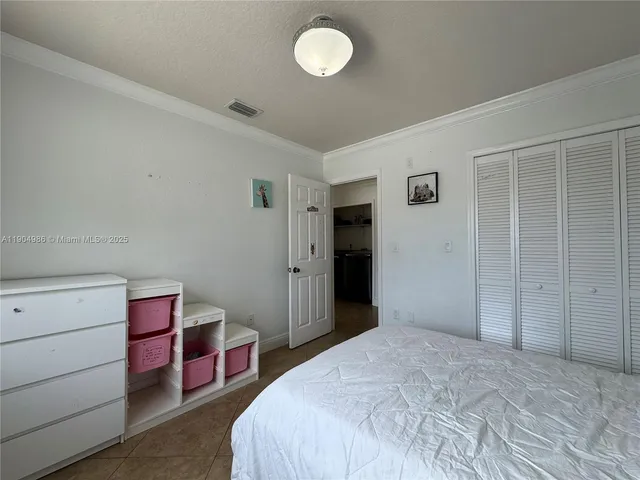 a bedroom with a bed and closet