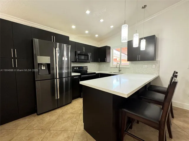 a kitchen with a refrigerator a sink and a stove