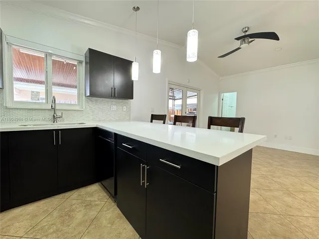 a kitchen with a sink and a mirror