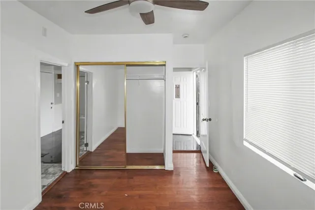 a view of a hallway with wooden floor and entryway