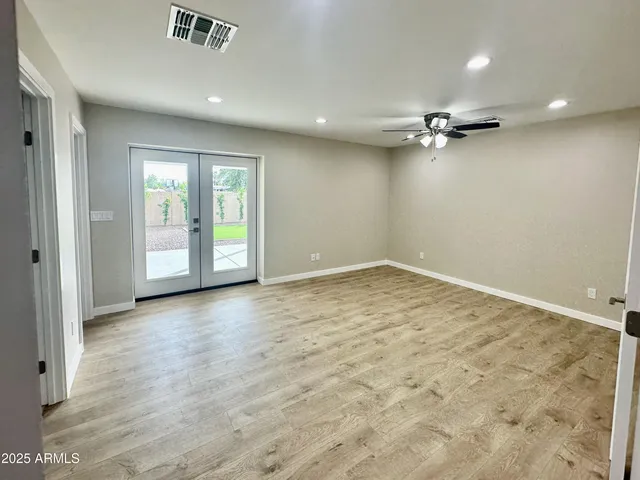 an empty room with a empty space and windows