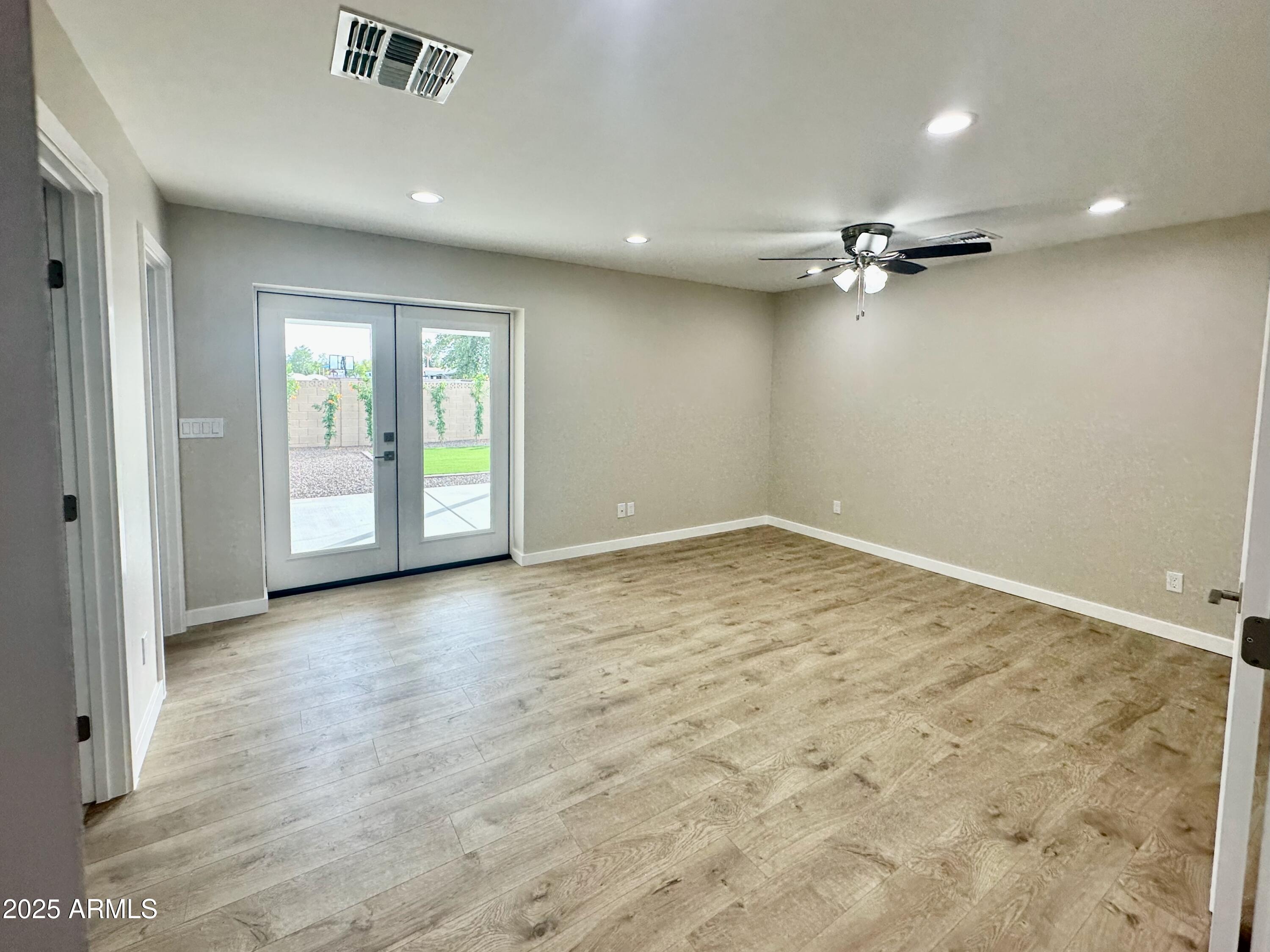 2329 East Enrose Street Mesa, AZ 85213 - Photo 13 of 30 an empty room with a empty space and windows