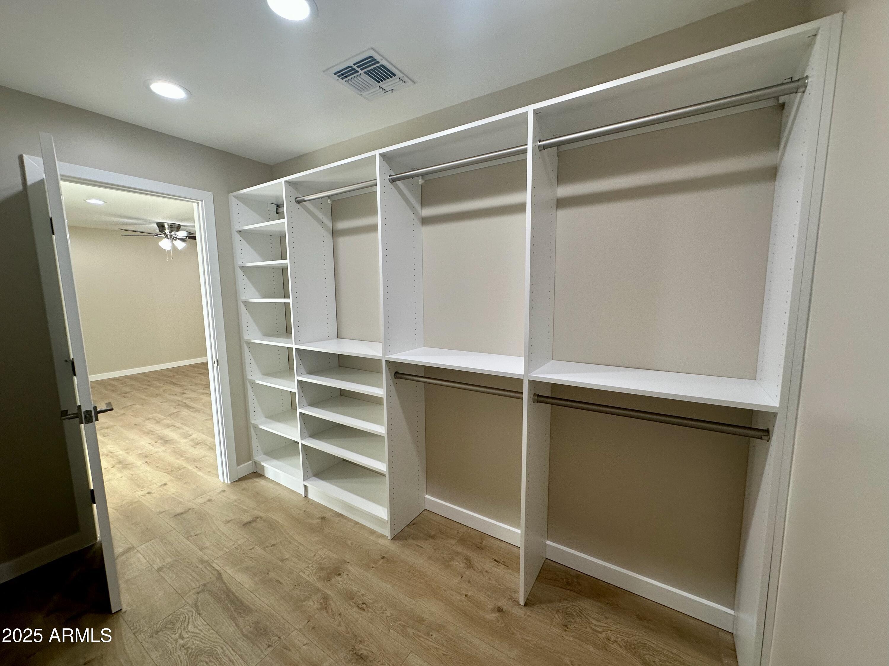 2329 East Enrose Street Mesa, AZ 85213 - Photo 18 of 30 a view of walk in closet with empty racks