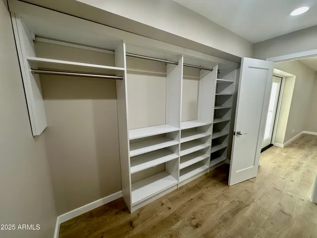 a view of walk in closet with empty racks