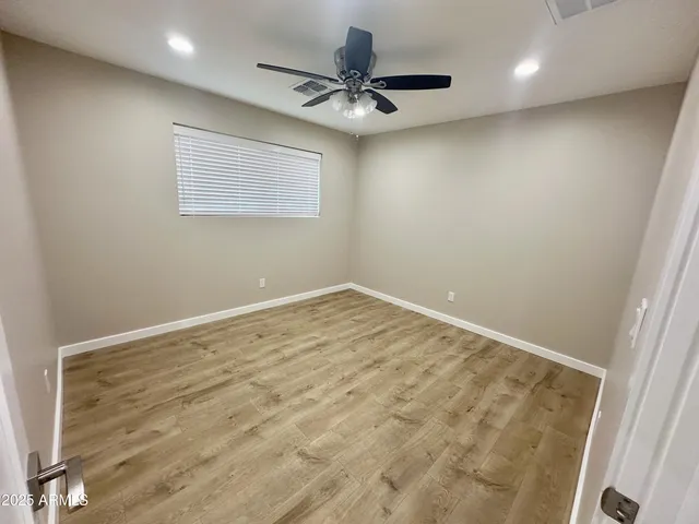a view of a livingroom with a ceiling fan and window