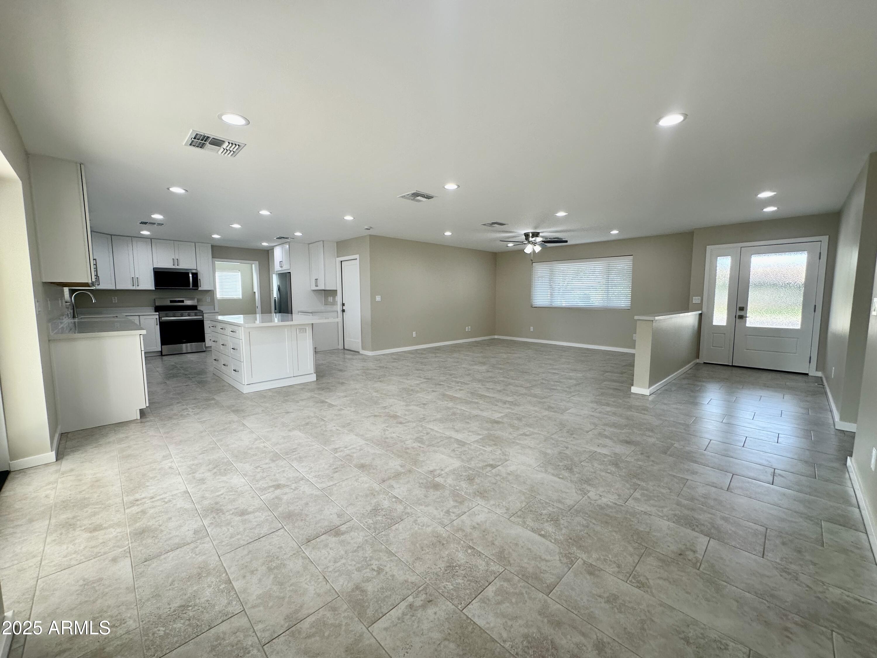 2329 East Enrose Street Mesa, AZ 85213 - Photo 5 of 30 a view of a kitchen with a sink and a stove top oven