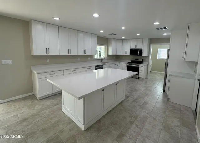 a kitchen with a sink stove and cabinets