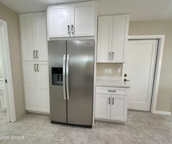 a kitchen with stainless steel appliances granite countertop a refrigerator and a stove