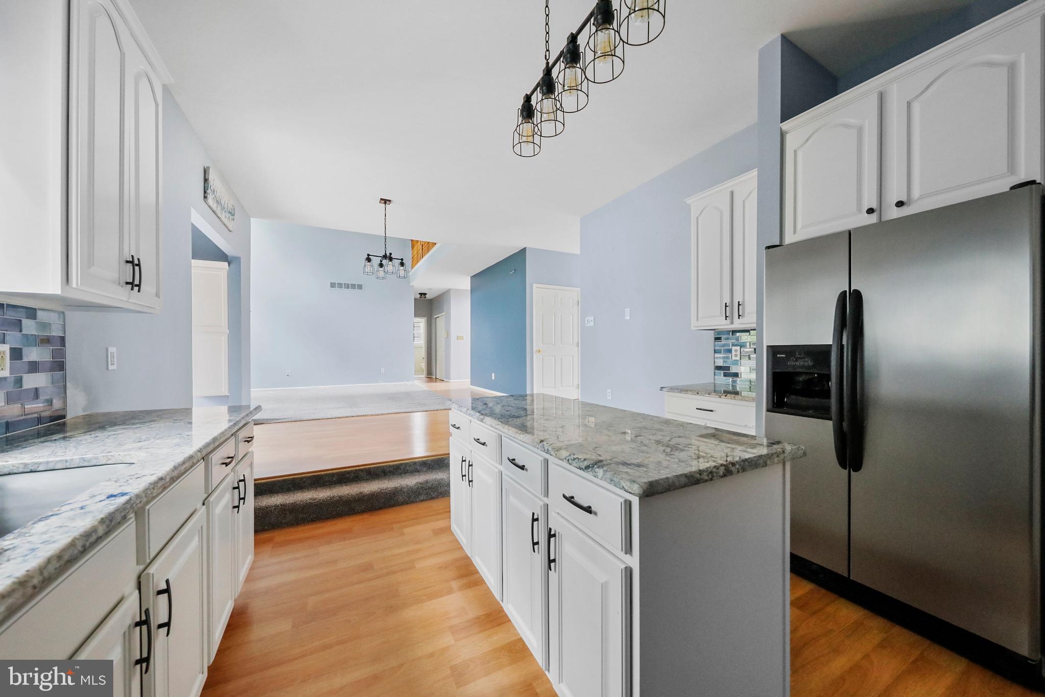 19 Pear Tree Place Sewell, NJ 08080 - Photo 11 of 47 a kitchen with granite countertop a sink and a refrigerator